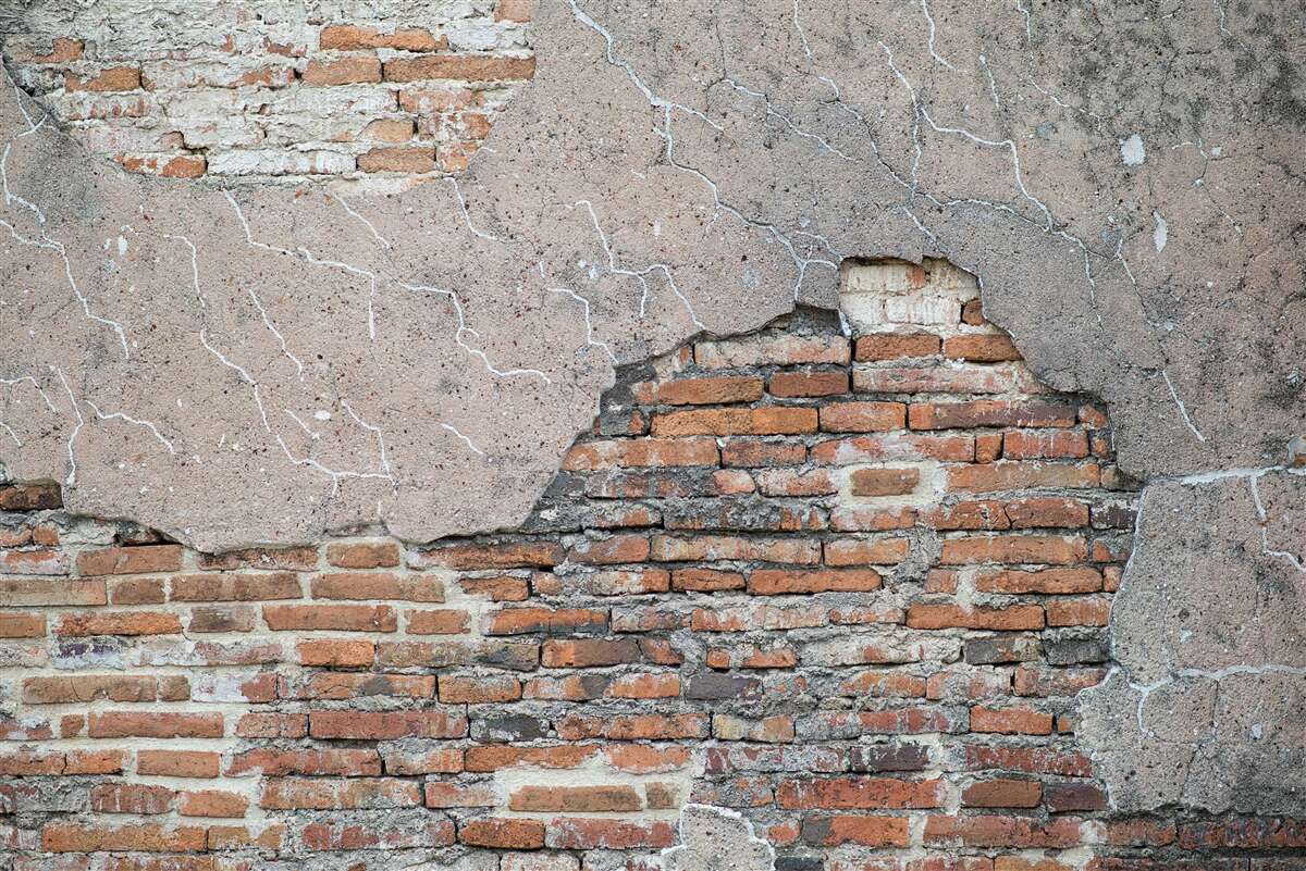 Fototapeten Ziegelmauer, die zusammenbricht