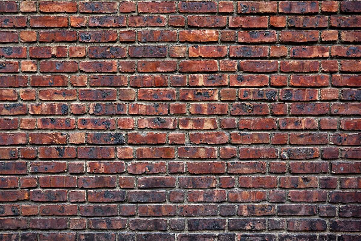 Fototapeten Antike Wand aus dunklem Ziegelstein