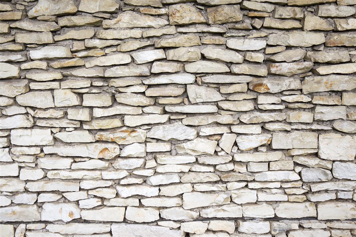 Fototapeten Eine Wand aus alten strukturierten Stein