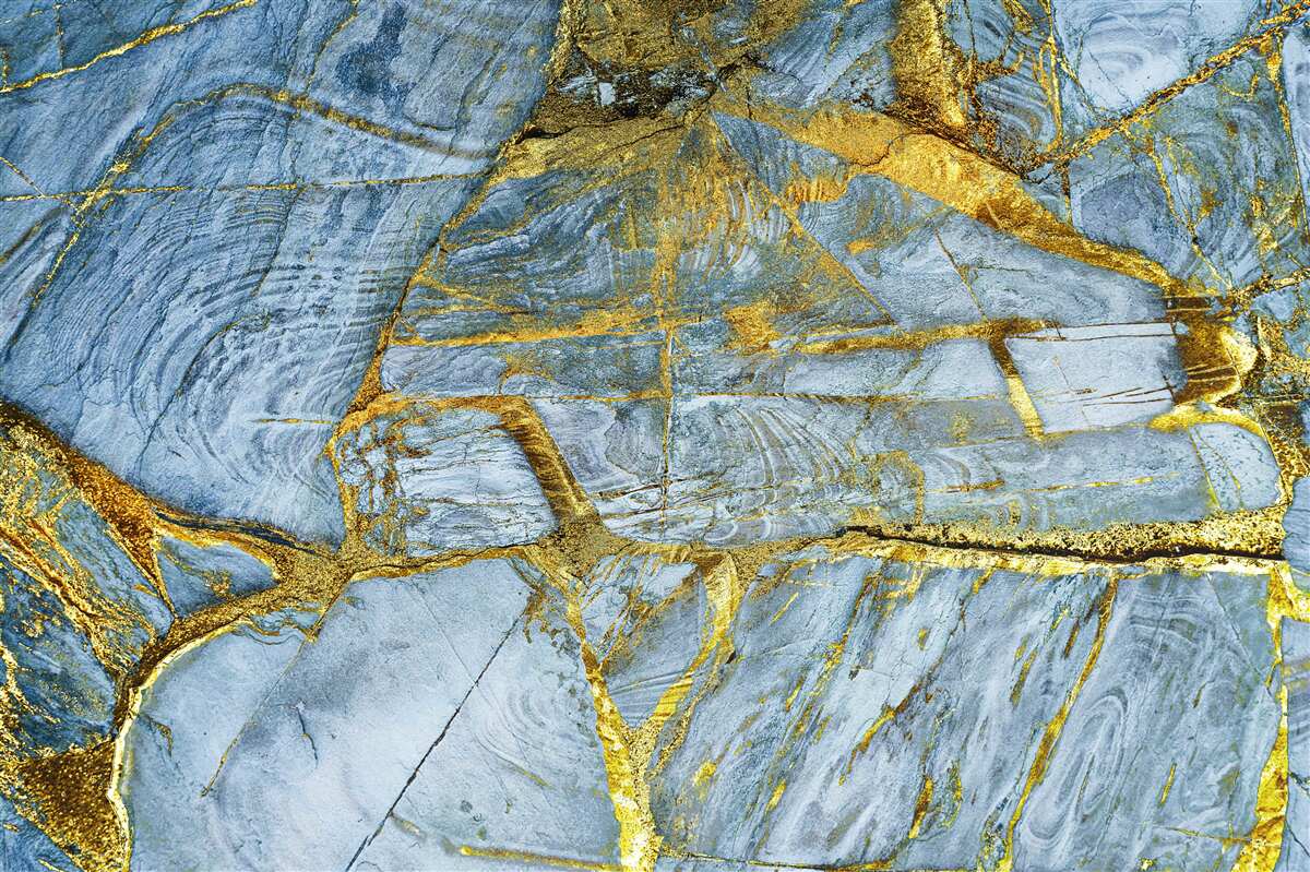 Fototapeten Schneiden mit goldenen Farbtönen auf blauem Hintergrund