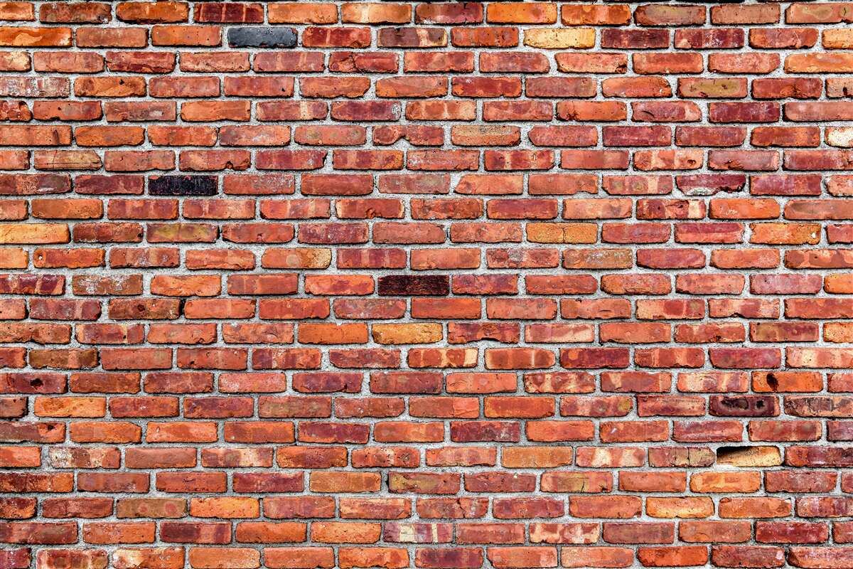 Fototapeten Eine Wand aus alten Ziegeln