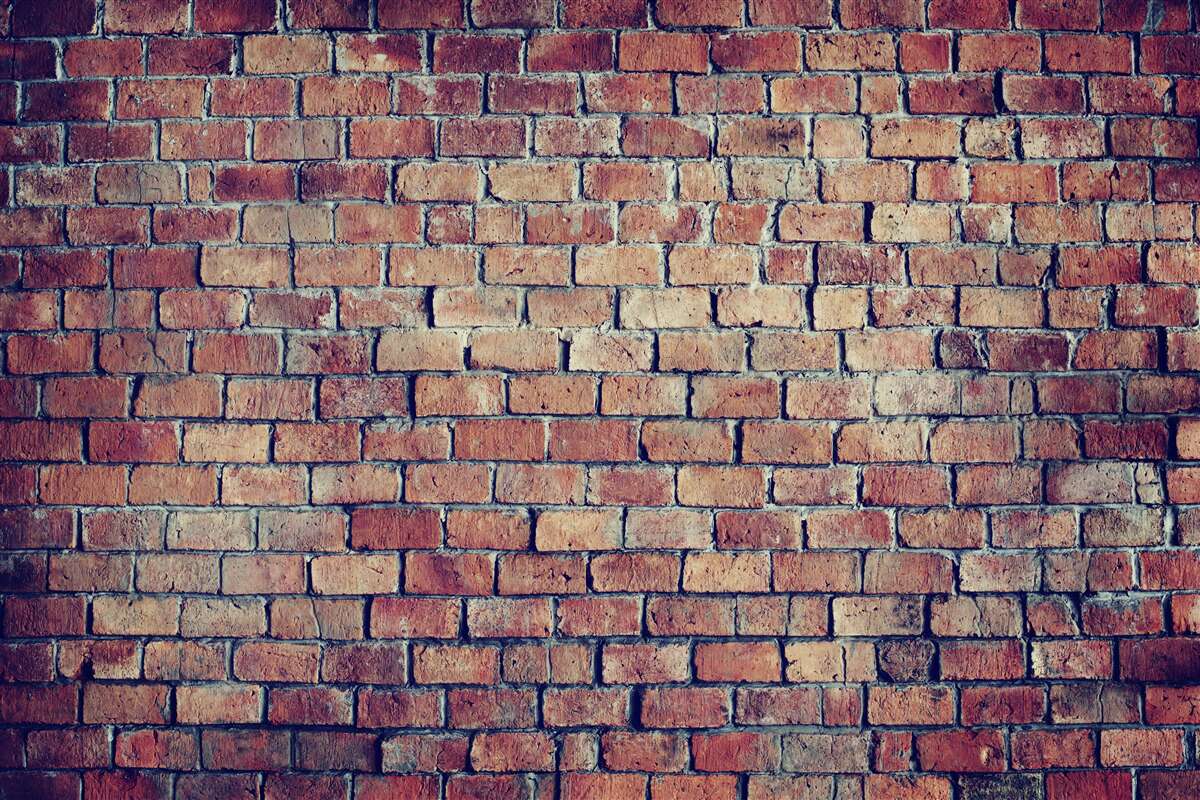Fototapeten Eine Wand aus rotem Ziegelstein