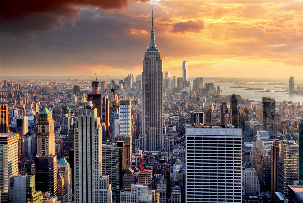 Fototapeten Die Sonne untergeht über New York