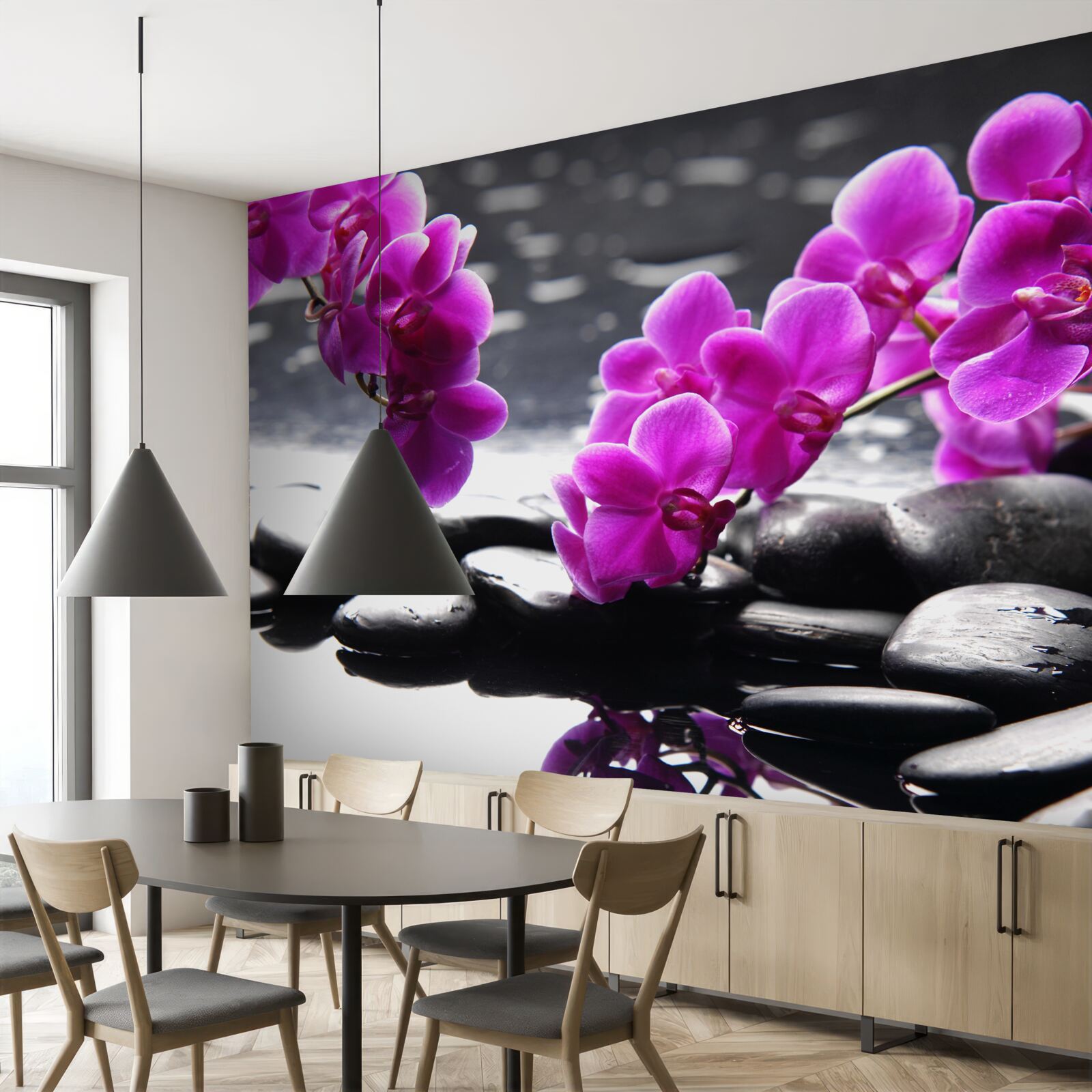 Fototapeten Eine Orchidee mit einem lila Farbton, eingebettet auf matte schwarze Steine