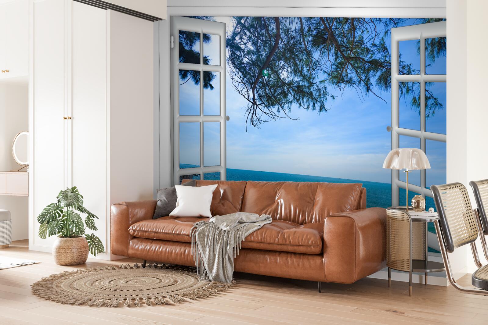 Fototapeten Ein Fenster, aus dem das blaue Meer zu sehen ist