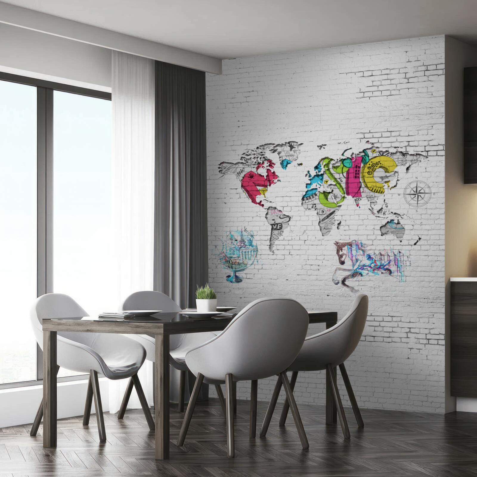 Fototapeten Karte der Welt in verschiedenen Farben an einer weißen Wand